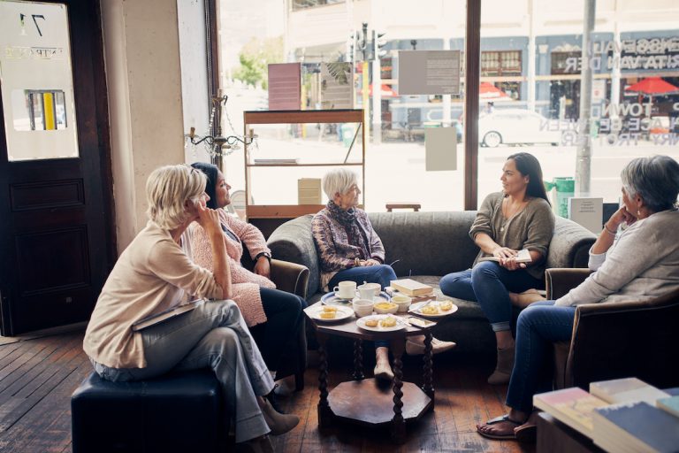 Shot of a group of women attending a book club meeting at a bookstore