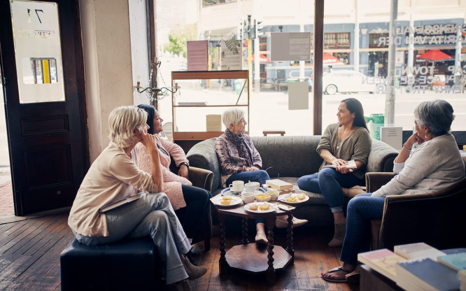 Shot of a group of women attending a book club meeting at a bookstore