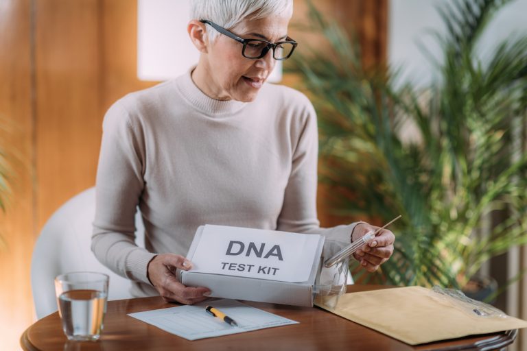 Senior Woman Doing a Mailed DNA Test at Home