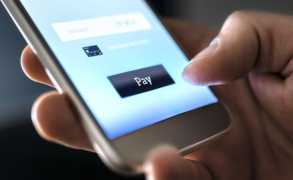 person paying with mobile phone